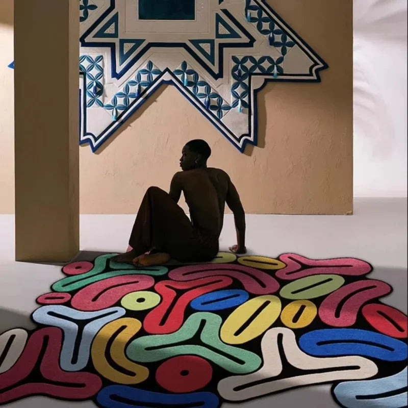 Person sitting on a Artistic Irregular Plush Carpet with a geometric wall design in the background.