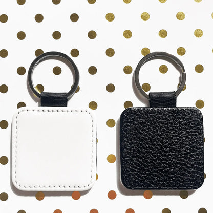 Custom Keychain square option, one white and one black with a textured finish, on a polka dot background.