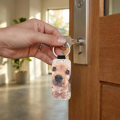 Hand holding a Custom Keychain with a dog's face on it, unlocking a wooden door.