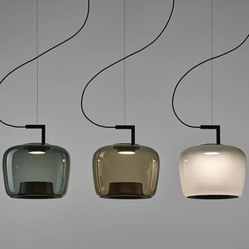 Danish glass pendant light in three colors hanging from the ceiling, showcasing a sleek and modern design.