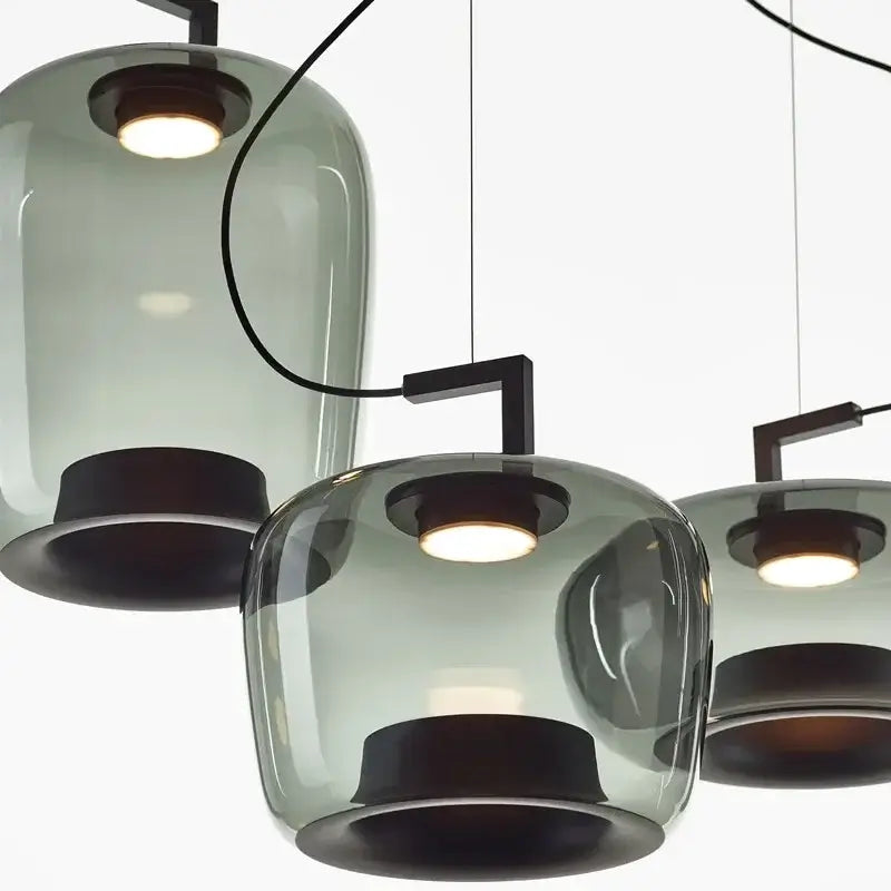 Modern chandelier with glass shades and black metal accents on a white background