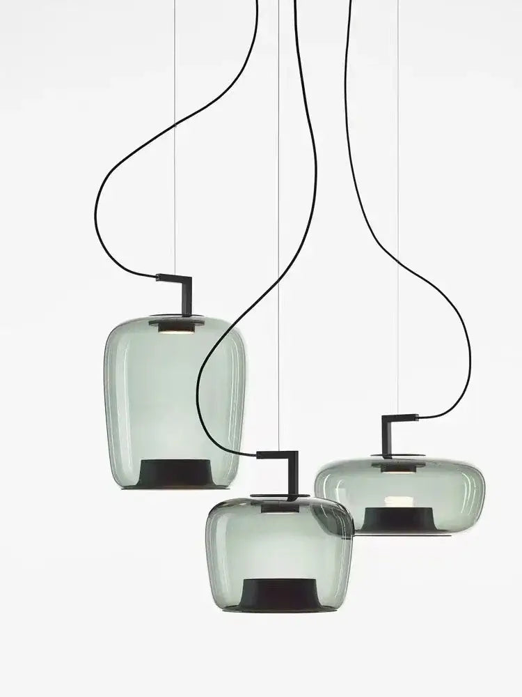 Three modern pendant lights with smoked glass shades on a white background