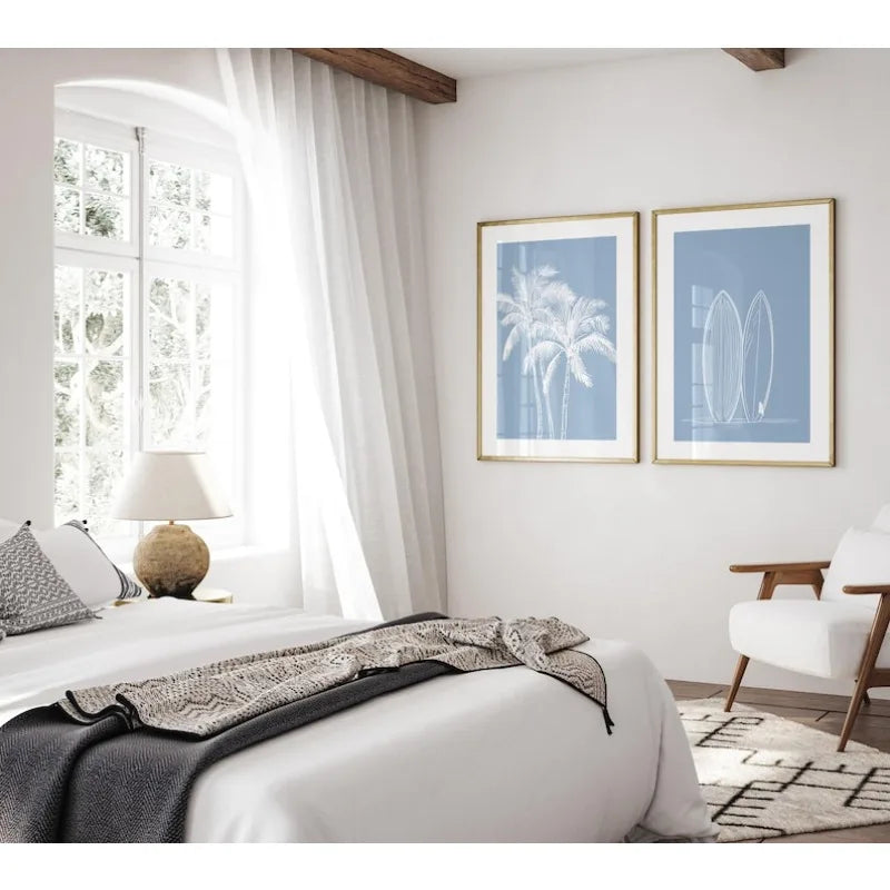 Modern bedroom with white bed, lamp, and wall art