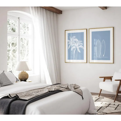 Modern bedroom with white bed, lamp, and wall art