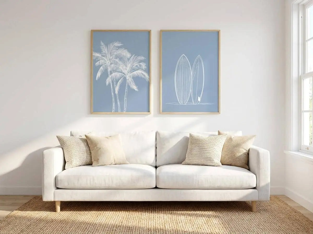 White sofa with decorative pillows in a room with Tropical Coastal Wall Art on the wall.