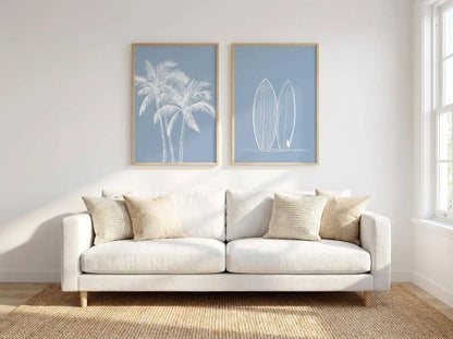 White sofa with decorative pillows in a room with Tropical Coastal Wall Art on the wall.