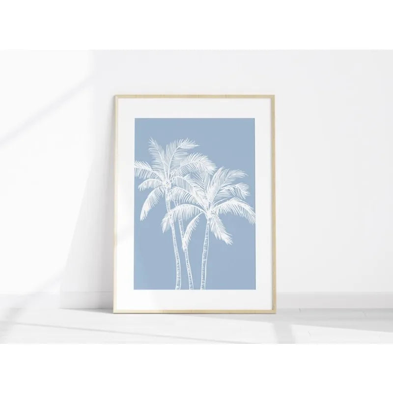 Framed artwork with white palm trees on a light blue background
