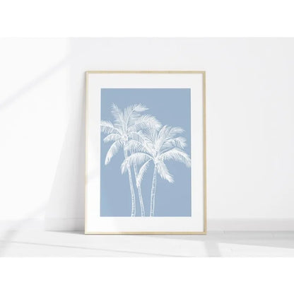 Framed artwork with white palm trees on a light blue background