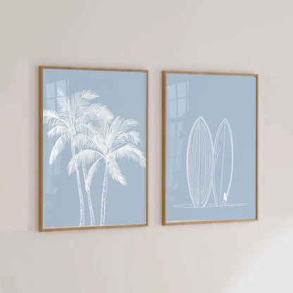 Tropical Coastal Wall Art prints of palm trees and surfboards on a light gray wall.